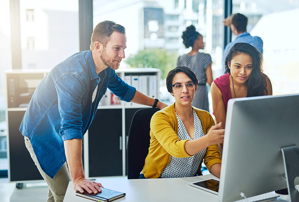 Business development team collaborating at a workstation