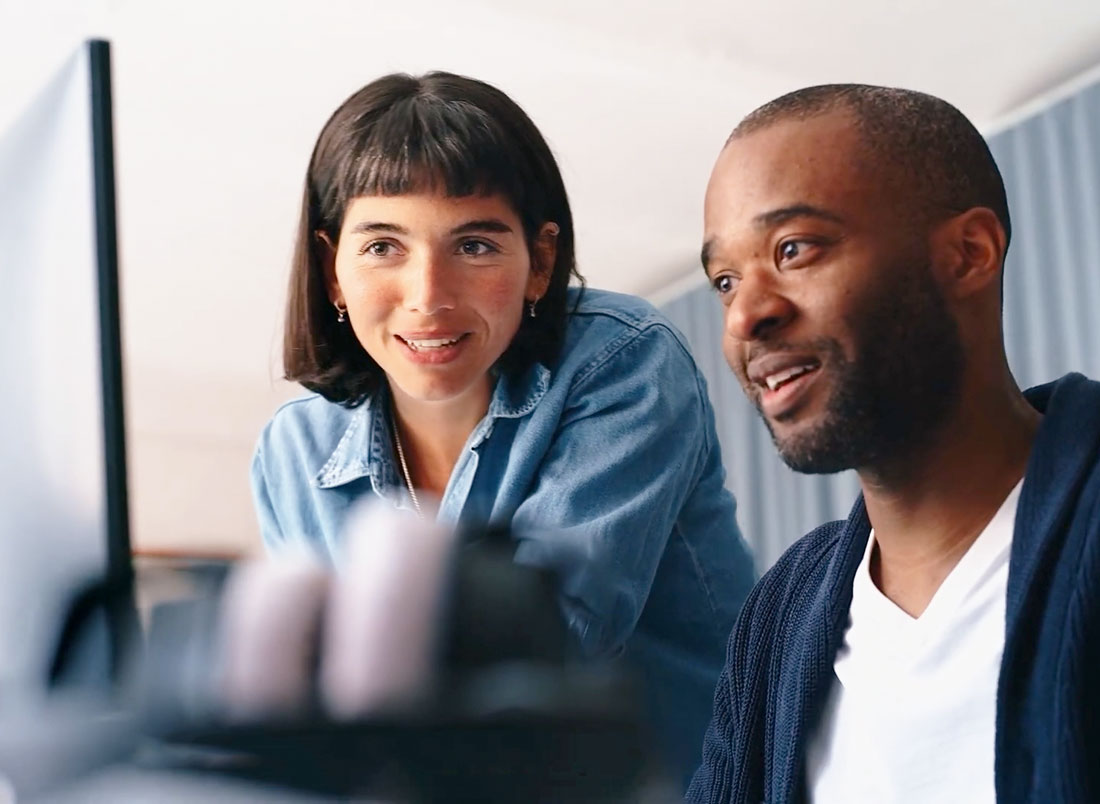 A law firm's in-house IT lead and an ALT specialist reviewing systems together at a monitor