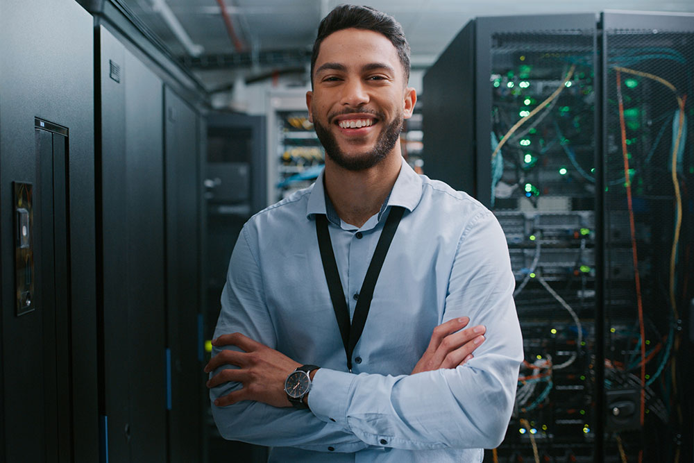 Technician standing confidently in a secure server room