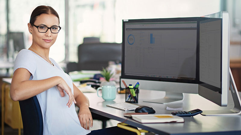 Office manager reviewing predictable monthly IT costs at her desk
