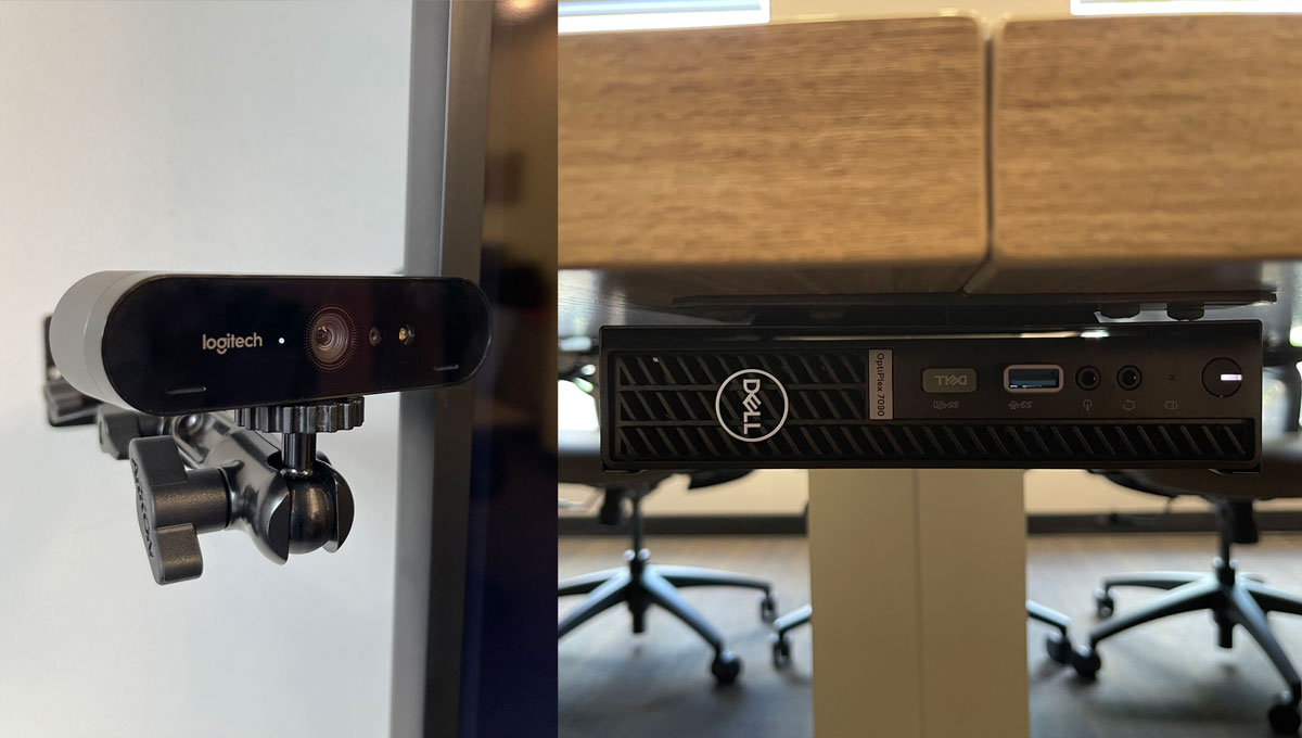 Wall-mounted Logitech camera and the discreet Dell PC mounted under the boardroom table