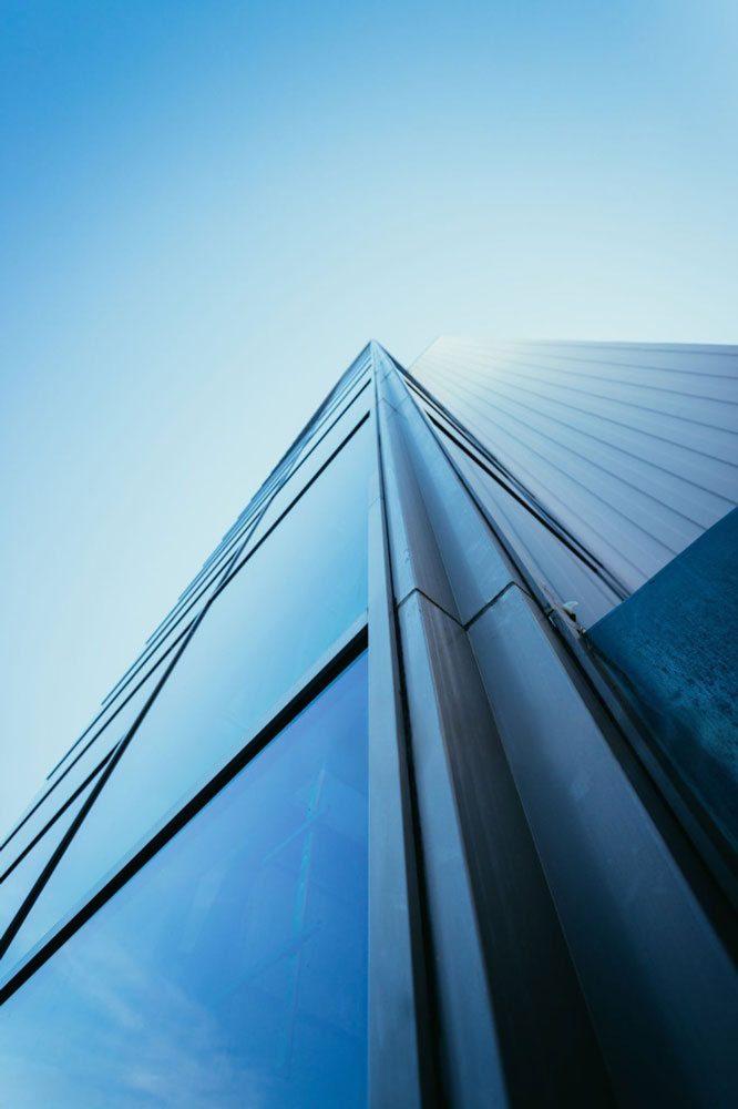 Glass office tower seen from below